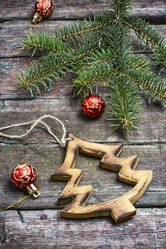 Christmas toy, vintage wooden Christmas tree on background with Christmas fir