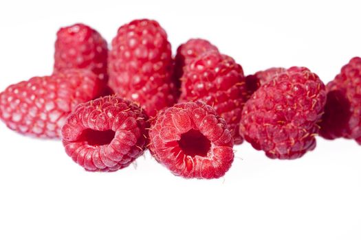 Group of red raspberries isolated on white background, close up