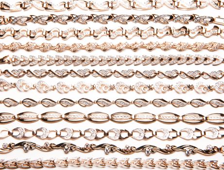 Golden bracelets and violin on isolated white background