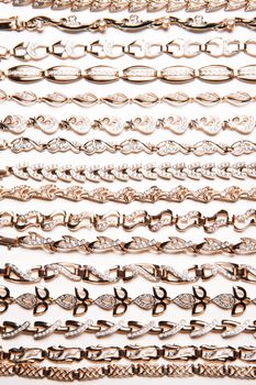 Golden bracelets and violin on isolated white background
