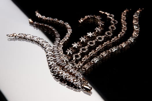 Golden bracelets on a studio background