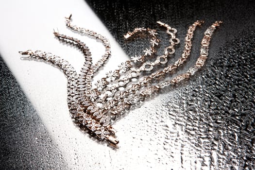 Golden bracelets on a studio background