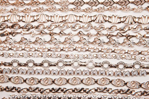 Golden bracelets on a studio background