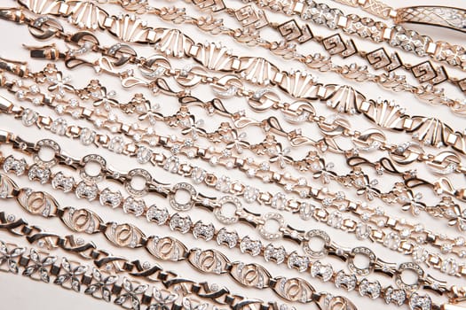 Golden bracelets on a studio background