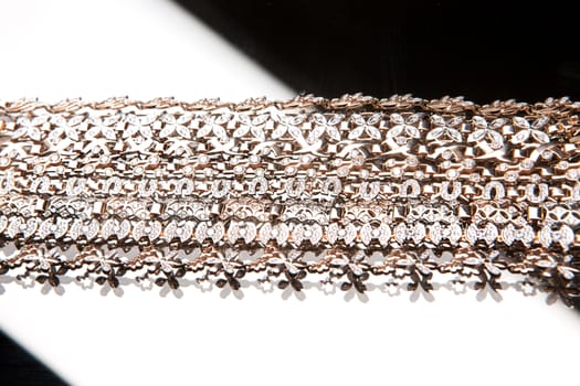 Golden bracelets on a studio background