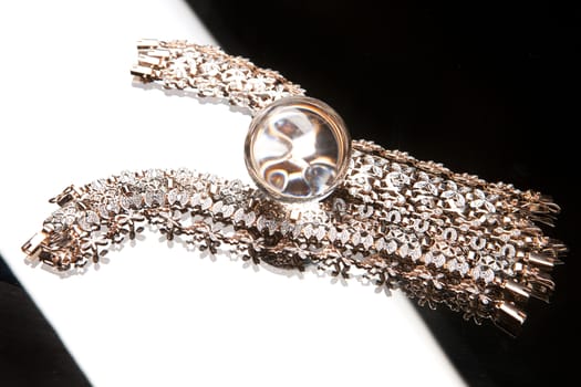 Golden bracelets on a studio background