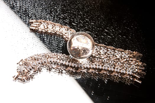 Golden bracelets on a studio background