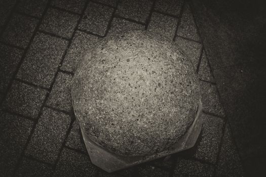 Black and white ground cement ball in an alley