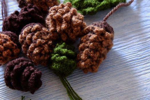 Group of knitted pinecone from brown yarn to decor for Xmas holiday, pine cone is popular Christmas ornament in wintertime