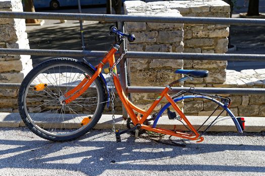 bicycle  abandoned on the street, dismounted one wheel