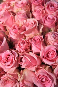 Pink roses in a big bridal bouquet and centerpieces