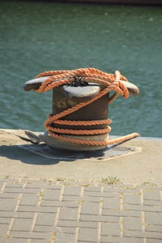 rusty mid size bollard in a port