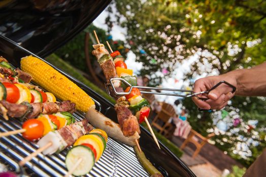 Assorted delicious grilled meat with vegetable over the coals on a barbecue