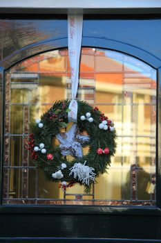 Classic christmas wreath with decorations on a door