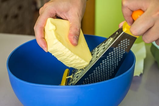 hand shredded cold butter with grated in a blue bowl