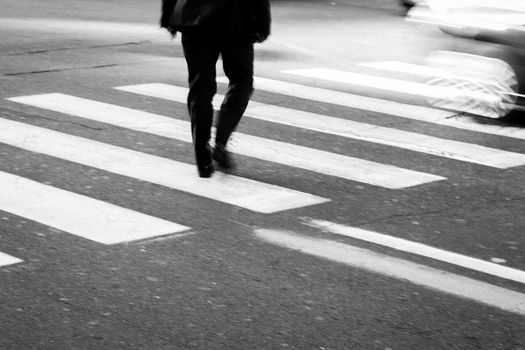 Men walking on zebra crossing street.