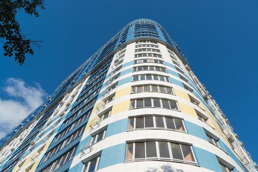 modern multi-storey residential building on a background of blue sky