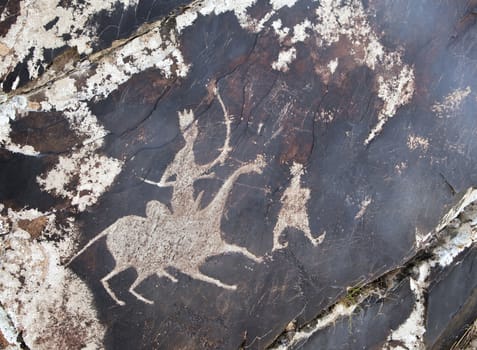 Ancient petroglyph carved in rock, Sarmishsay, Uzbekistan