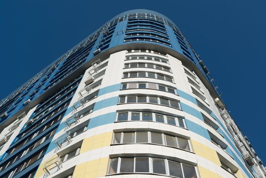 modern multi-storey residential building on a background of blue sky