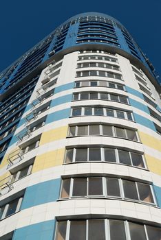 modern multi-storey residential building on a background of blue sky