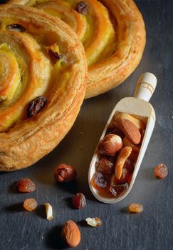 Fresh sweet swirl  with raisins on ardesia table