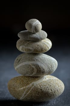 stack of  pebble stones on black background