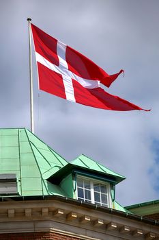 Waving Danish flag on the mast in Copenhagen, Denmark