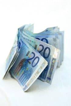 stacked 20 euro banknotes on white background