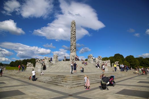 EDITORIAL OSLO, NORWAY - AUGUST 18, 2016: Many tourist walk Vigeland Sculptures Park in the popular Vigeland park ( Frogner Park ), designed by Gustav Vigeland in Oslo, Norway on August 18, 2016. 