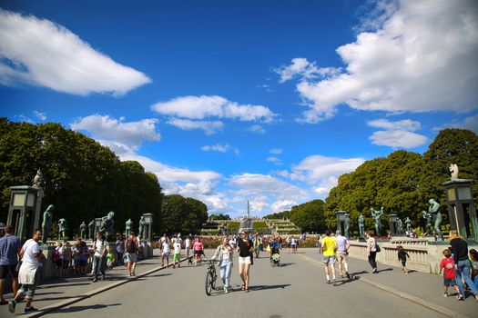 EDITORIAL OSLO, NORWAY - AUGUST 18, 2016: Many tourist walk Vigeland Sculptures Park in the popular Vigeland park ( Frogner Park ), designed by Gustav Vigeland in Oslo, Norway on August 18, 2016. 