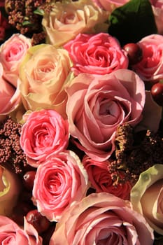 Pastel roses in different shades of pink in a bridal arrangement