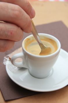 Man stiring an espresso