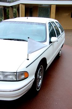 White hearse, funeral service car, on a cemetary