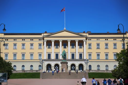 OSLO, NORWAY – AUGUST 17, 2016: Tourist visit The Royal Palace and statue of King Karl Johan XIV, Oslo is the capital city of Norway in Oslo, Norway on August 17,2016.