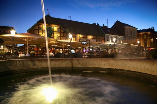 MALMO, SWEDEN - AUGUST 16, 2016: View of beautiful night scene and fountain on the market place Lilla Torg in Malmo, Sweden on August 16, 2016.