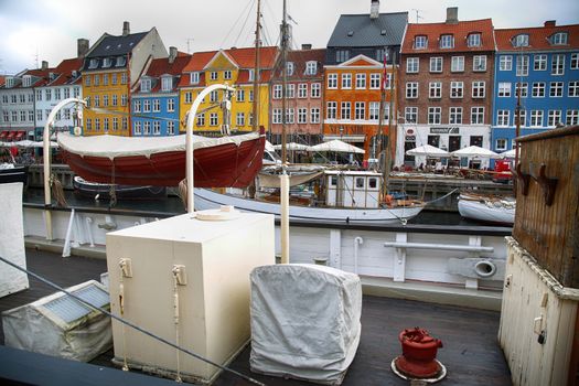 COPENHAGEN, DENMARK - AUGUST 15, 2016: Boats in the docks Nyhavn, people, restaurants and colorful architecture. Nyhavn a 17th century harbour in Copenhagen, Denmark on August 15, 2016.