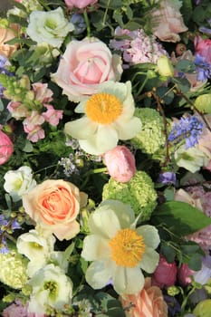 Mixed bridal flower decorations: peonies, ranunculus and roses in pastel colors