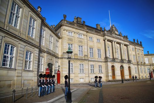 COPENHAGEN, DENMARK - AUGUST 15, 2016: Danish Royal Life Guards on the central plaza of Amalienborg palace, home of the Danish Royal family in Copenhagen, Denmark on August 15, 2016.