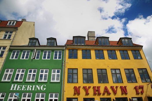 COPENHAGEN, DENMARK - AUGUST 14, 2016: Restaurant "Heering" and tourist cafe "Nyhavn 17" on the waterfront of Nyhav in Copenhagen, Denmark on August 14, 2016.