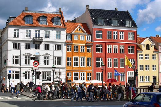COPENHAGEN, DENMARK - AUGUST 14, 2016: Boats in the docks Nyhavn, people, restaurants and colorful architecture. Nyhavn a 17th century harbour in Copenhagen, Denmark on August 14, 2016.
