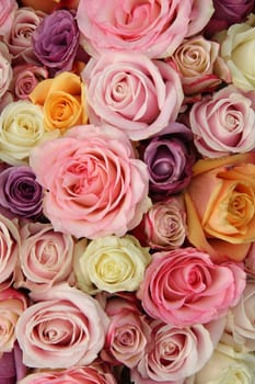 Mixed roses in various pastel colors in a wedding arrangement