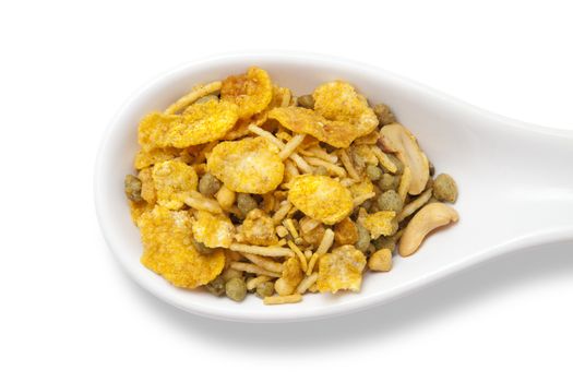 Dry roasted Indian snack mix in a big spoon, isolated