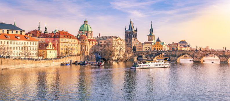 Panorama of Prague city, the capital of Czech Republic, with the Vltava river, the Charles Bridge and  surrounding buildings, on a sunny day of March.