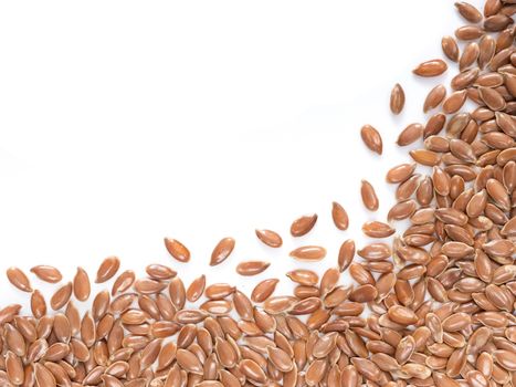 Brown flax seed with copy space. Isolated one edge. Top view or flat lay