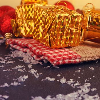 Christmas decorative gift box, ball and drum on black background