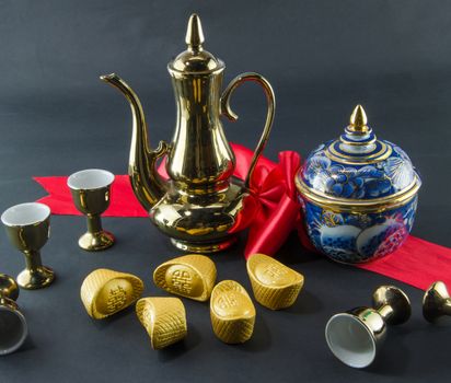Gold ingot Benjarong  Red ribbon bow Gold jug Tea glass wedding Chinese  black background