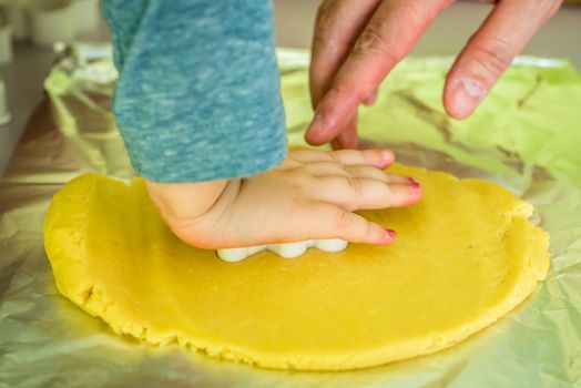 child makes shape of shortcrust dough with cookie cutters