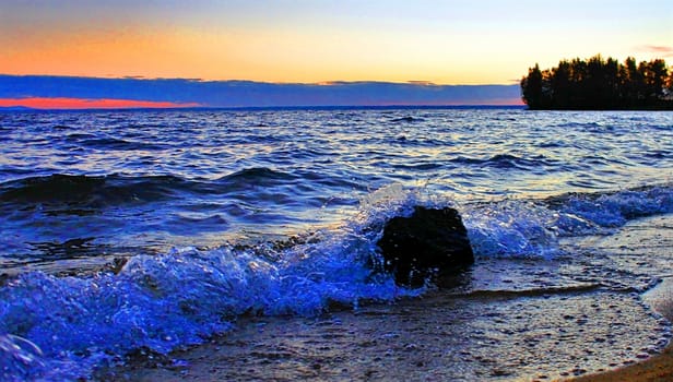 Beautiful sunrise on the lake in windy weather