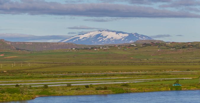 The volcano Hekla in Iceland shot in summer, old overrgrown lavafield in the foreground