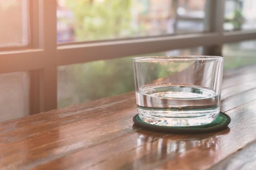Glasses of water on a wooden table. Selective focus. Shallow DOF.
